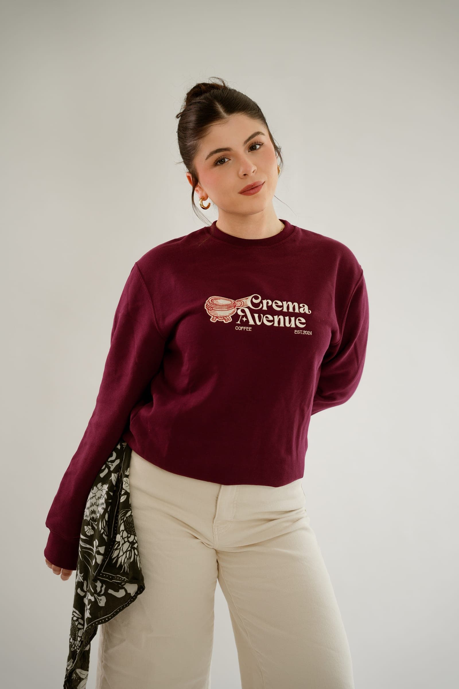 Brianna, founder of Crema Avenue, in the maroon crewneck